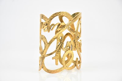 Lot 251 - YVES SAINT LAURENT; a gold tone hammered metal...