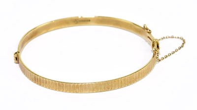 Lot 178 - A 9ct yellow gold hinged snap bangle with...