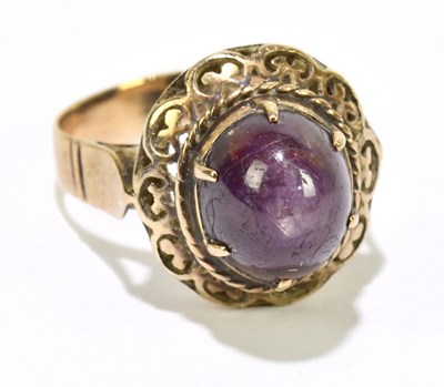 Lot 1079 - A yellow metal and star ruby domed cabochon...
