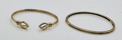 Lot 680 - A 9ct yellow gold bangle, with row of...