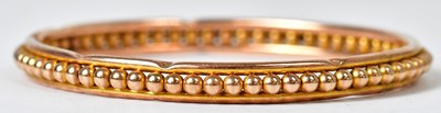 Lot 1194 - A 9ct gold beaded bangle, diameter 9cm, approx....