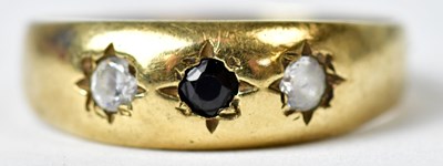 Lot 1168 - A 9ct gold ring set with a blue stone flanked...