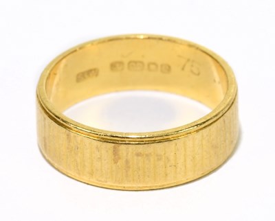 Lot 1061 - A 22ct ribbed gold wedding band, size J 1/2,...