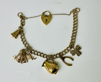 Lot 681 - A 9ct yellow gold charm bracelet, set with...