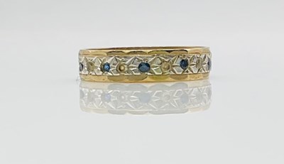 Lot 782 - A yellow and white metal full eternity ring,...
