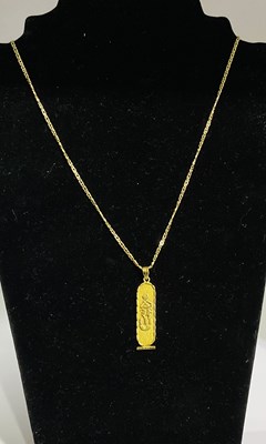 Lot 672 - A yellow metal ankh pendant, suspended on a...