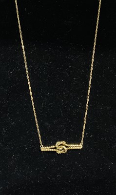 Lot 721 - A 9ct yellow gold necklace with lover's knot...