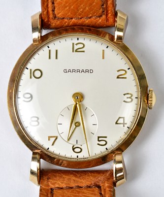 Lot 1383 - GARRARD; a 9ct gold wristwatch, white dial set...