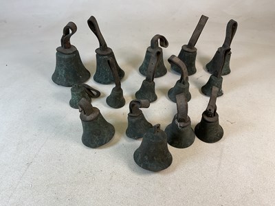 Lot 23 - A group of fifteen graduated handbells with...