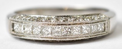 Lot 1152 - An 18ct white gold half eternity ring, set...