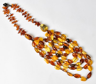 Lot 1281 - A multi-strand amber beaded necklace strung on...