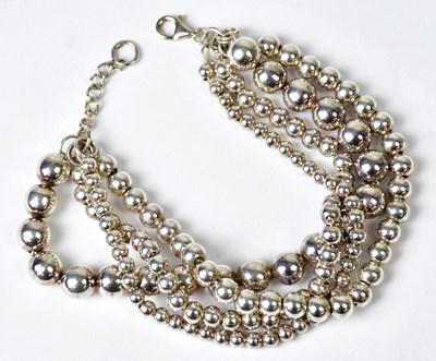 Lot 1212 - A 925 silver four-strand beaded bracelet,...