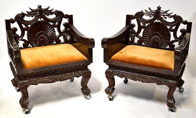Lot 58 - A pair of carved and stained elbow chairs,...