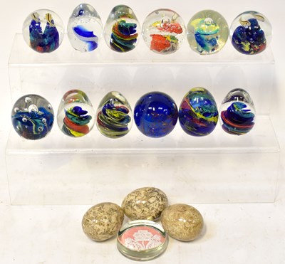 Lot 348 - A collection of twelve glass paperweights,...