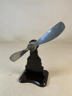 Lot 140 - An aluminium propeller mounted on a wooden...