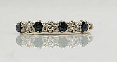 Lot 752 - A 9ct yellow gold, seven stone half eternity...