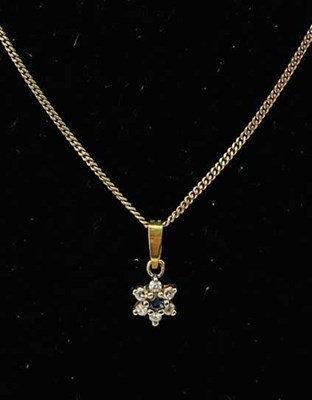 Lot 750 - A yellow metal fine link chain suspending a...