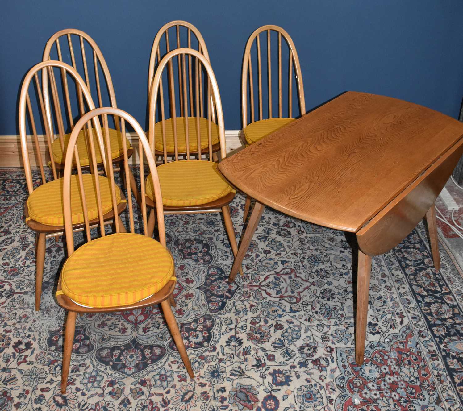 Lot 571 - ERCOL; a light elm drop-leaf dining table,