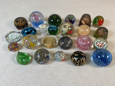Lot 439 - A group of paper weights, some glass and some...