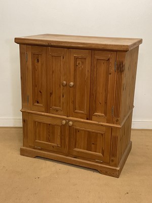 Lot 897 - A pine cupboard with double folding panel...