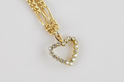 Lot 2171 - A yellow metal heart shaped pendant set with...