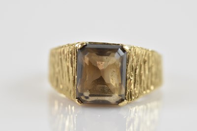 Lot 2466 - A 9ct yellow textured gold dress ring, set...