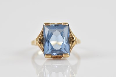 Lot 2467 - A yellow metal dress ring set with a pale blue...
