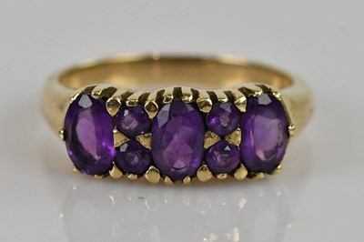 Lot 2462 - A 9ct yellow gold amethyst set seven stone...