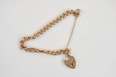 Lot 1152 - A yellow metal curb link bracelet,...