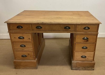 Lot 905 - A pine pedestal desk with an arrangement of...