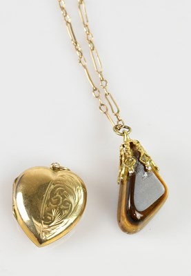 Lot 2219 - A yellow metal mounted tiger's eye pendant,...