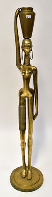 Lot 92 - A large African brass figure of a woman...