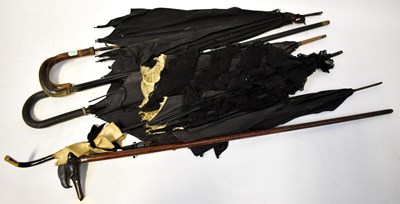 Lot 793 - A collection of walking sticks and umbrellas,...