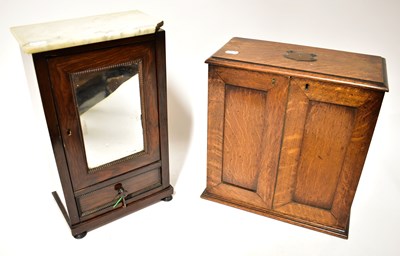 Lot 777 - An Edwardian oak tobacco cabinet with fitted...