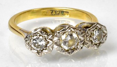 Lot 1149 - An 18ct gold diamond set three-stone ring,...