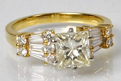 Lot 1183 - An 18ct yellow gold diamond ring, the central...