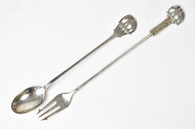 Lot 1071 - An Indian white metal spoon and pickle fork,...