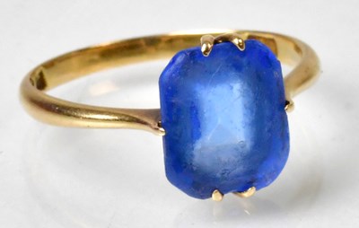 Lot 1174 - An 18ct yellow gold and blue stone dress ring,...
