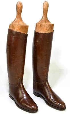 Lot 2429 - A pair of of tan leather riding boots, with...