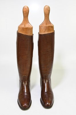 Lot 2429 - A pair of of tan leather riding boots, with...