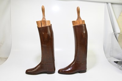 Lot 2429 - A pair of of tan leather riding boots, with...