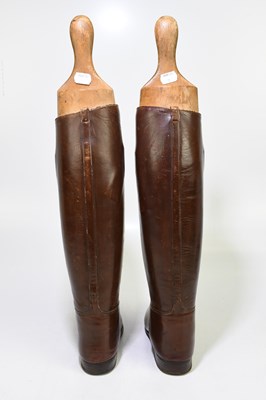 Lot 2429 - A pair of of tan leather riding boots, with...