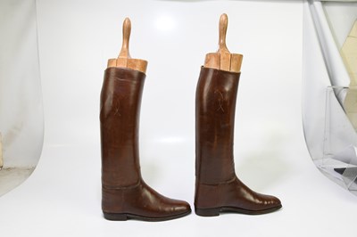 Lot 2429 - A pair of of tan leather riding boots, with...