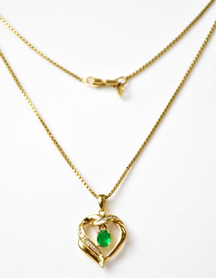 Lot 1266 - A yellow metal diamond and emerald...