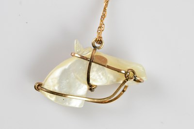 Lot 2141 - A yellow metal mounted mother of pearl pendant,...