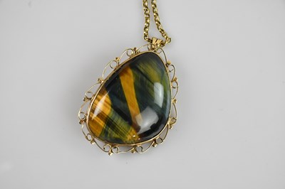 Lot 2087 - A yellow metal mounted tiger's eye pendant...
