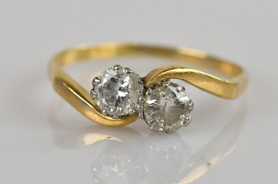 Lot 2322 - A yellow metal diamond two stone crossover...