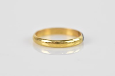 Lot 2496 - A yellow metal wedding band, indistinctly...