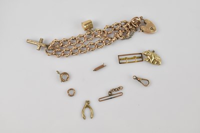 Lot 1224 - A yellow metal charm bracelet, stamped '9',...