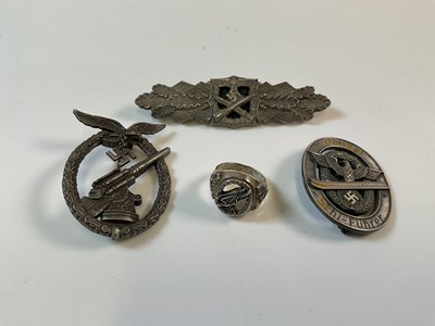 Lot 110 - Three WWII German badges, a Police Ski Leader...